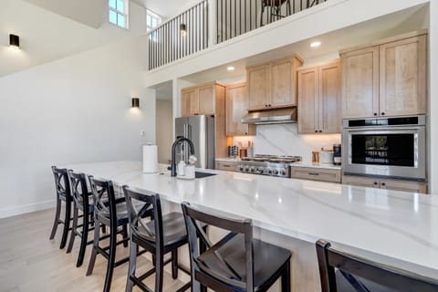 Step into our gourmet kitchen, featuring high-end appliances and a spacious island perfect for meal preparation and casual dining.