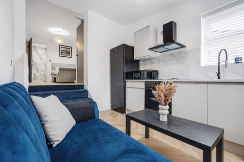 A bright, practical space with a comfy sofa bed, compact kitchenette, and washing machine — perfect for short stays or work trips. The kitchenette includes all the essentials for easy meals, while the sofa bed adds extra flexibility for guests.