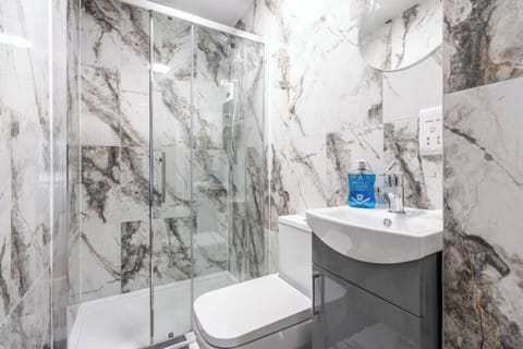 A clean and functional private bathroom with shower, toilet, and sink. Towels, hand soap, and toilet rolls are provided for your stay. Please note: body wash, shampoo, and other hair products are not supplied.