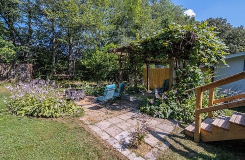 Private back yard with deck, fire pit, patio, covered area, and charcoal grill