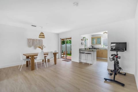 "Enjoy a seamless flow in our modern Airbnb. 🏠 The spacious dining area opens to a chef-ready kitchen and private patio, while the indoor fitness equipment ensures you never miss a workout during your short-term stay. ✨"