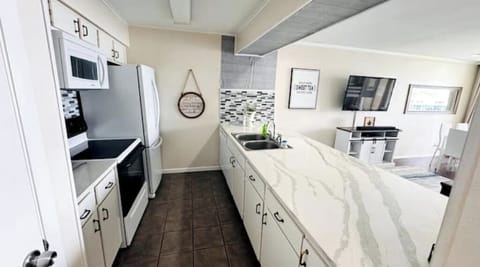 Open concept kitchen with a large counter built for entertaining. 