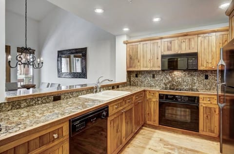 Cook in the modern kitchen, featuring granite countertops, high-end appliances, and plenty of storage space for all your culinary needs.