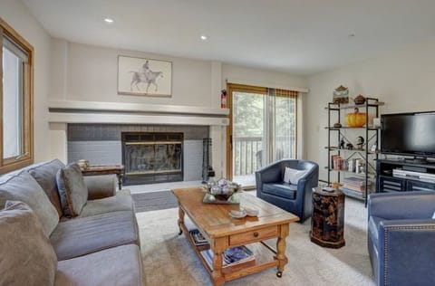 Gather in the elegant living room, featuring a cozy fireplace, plush seating, and tasteful decor, perfect for relaxing or entertaining.