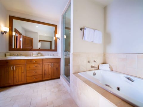 Unwind in our luxurious bathroom, offering a soaking tub, large vanity, and elegant finishes. A serene space for relaxation and self-care.