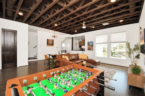 Entertainment is at your fingertips with a foosball table, TV, and dining area.