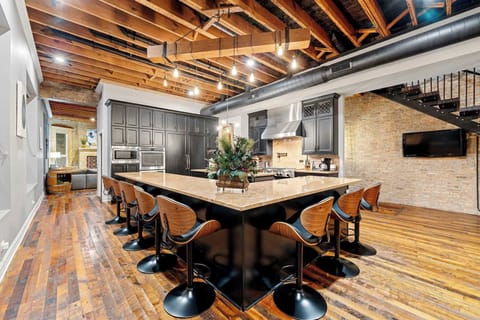 Sleek kitchen w/ dark cabinetry, stainless appliances, and a layout made for cooking together.