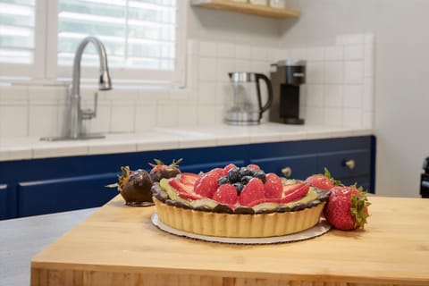 "Designer Kitchen Detail & Coffee Station"
Highlighting the clean tile backsplash, modern blue cabinetry, and ample prep space for your culinary creations.