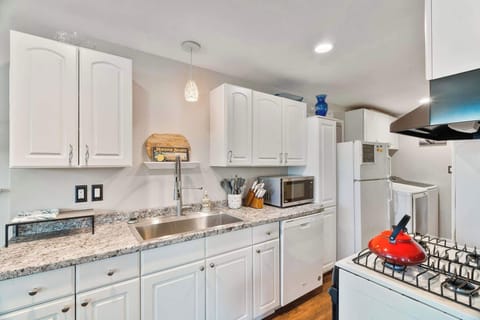 The kitchen is compact but fully equipped, stocked with high-quality pots, pans, and everything you need for cooking and baking.