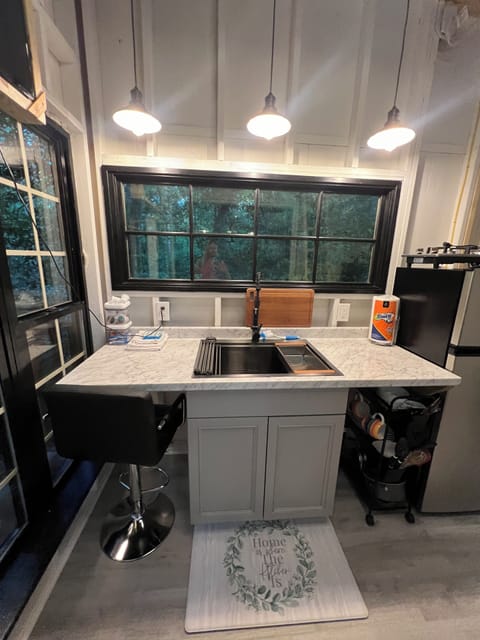 Kitchen has microwave, coffee maker and utensils