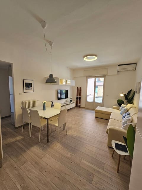 Spacious and bright living room with L shaped sofa, AC and a 50-inch Smart TV