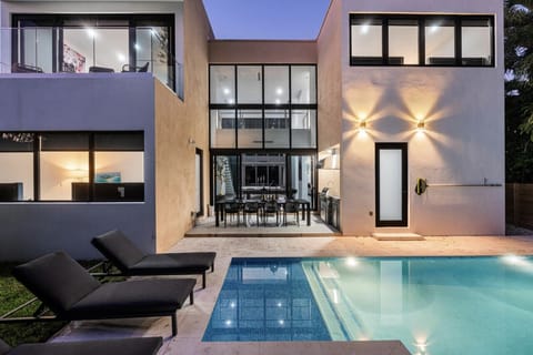 Nighttime brings a calming and relaxing vibe by the backyard pool.