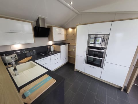 Enjoy the ultimate caravan holidays UK experience at Parkdean Resort's Valley Farm Holiday Park Clacton on Sea United Kingdom, where the kitchen area in a caravan makes self-catering a breeze.