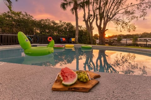 Vibrant pool scene with rainbow inflatables and tropical sunset views. Pure summer joy and relaxation #PoolParty #RainbowFloats #SummerVibes #TropicalSunset #PoolFun #ColorfulInflatables #SummerSwimming #PoolLife #TropicalParadise #OutdoorFun