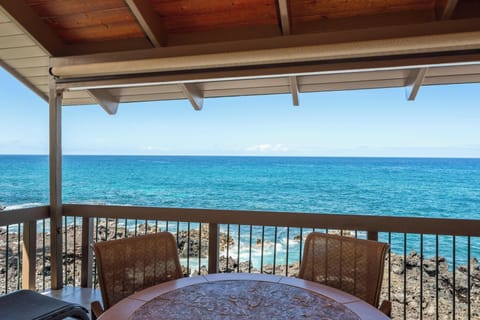 Imagine sipping your morning coffee at this covered terrace with turquoise waves just beyond your railing. The sea breeze and endless blue horizon make every moment here feel like pure escape.