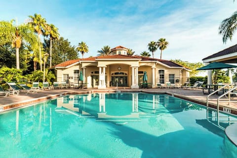 Sun loungers, outdoor tables and chairs next to the pool, hot tub and pool bar.
