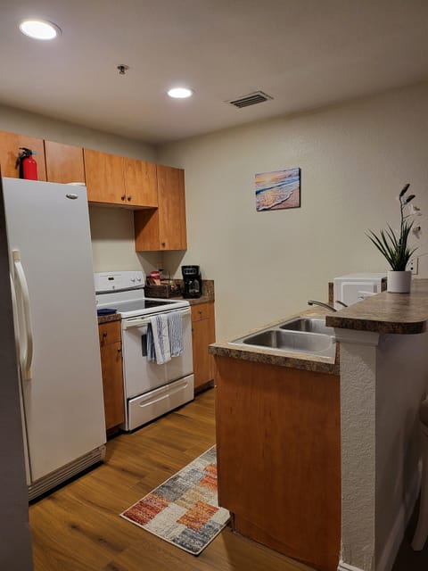Kitchen with stove, microwave, blinder and coffee maker. 