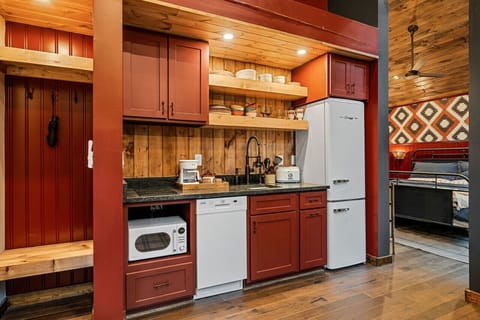 The kitchen features a two-burner electric cooktop, ice maker, microwave, toaster, blender, dishwasher, and refrigerator, along with a coffee maker that uses our custom Hideout coffee blend.