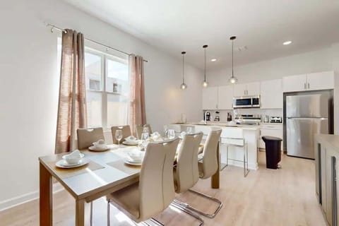 The dining area featured a rustic wooden table surrounded by comfortable chairs, perfect for enjoying meals with family and friends.