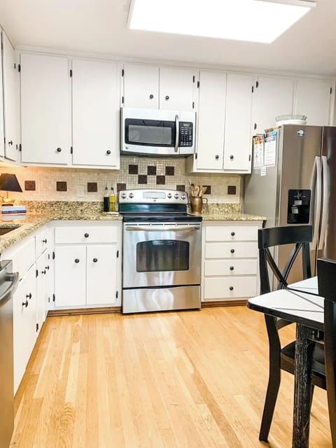 Fully stocked eat-in kitchen with stainless steel appliances