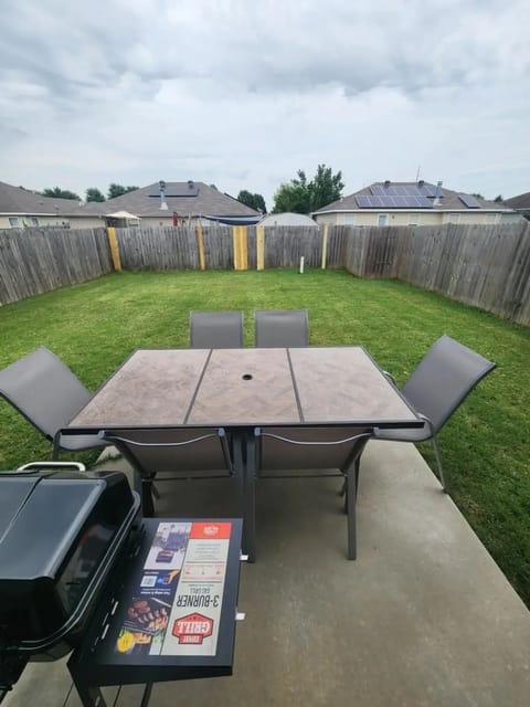 Fenced in back yard with grill