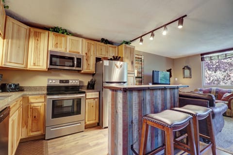 Kitchen offers an island with barstool seating