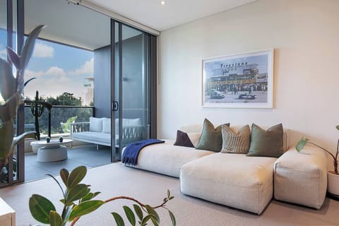 The open-plan living and dining area flows to the balcony, creating a lovely transition between indoors and out.
