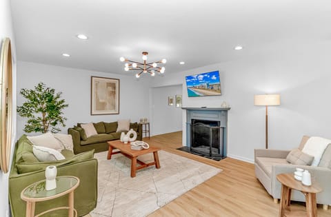Inviting living area with fireplace, comfortable seating and bright open layout ideal for gatherings