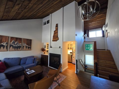 Main floor. Shared dining/living room space with kitchen, stairs up to open loft