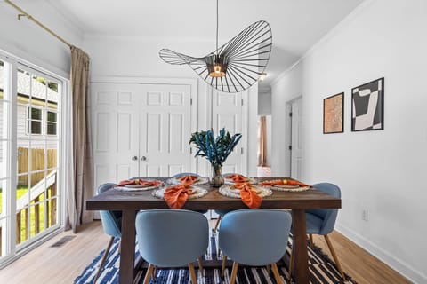 dining area with 6 plush seats with an elegant chandelier