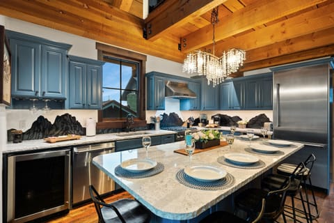 Our spacious, open-concept gourmet kitchen is fully stocked, making it perfect for cooking in your luxury mountain retreat.