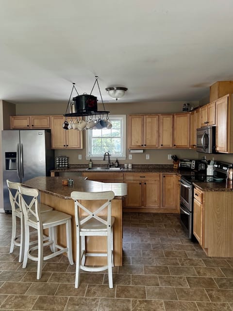 Fully equipped kitchen with ice maker, toaster oven, double ovens, microwave.