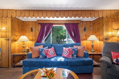 Vintage wood paneling, Cowboy designs, Southwest decor pillows, antique lamps.