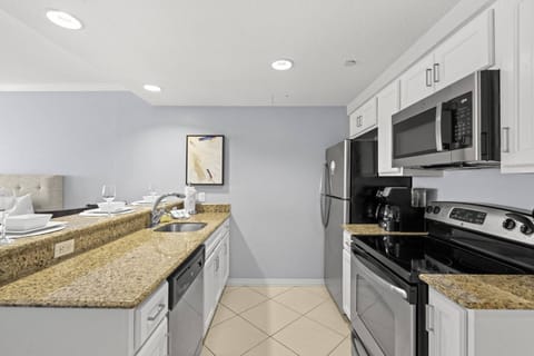 Fully Equipped Kitchen with Stainless Steel Appliances and a Breakfast Bar