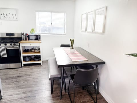 Share a meal or plan your day at the bright dining table, with the kitchen essentials just steps away.