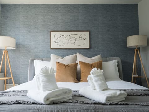 Step into this cozy bedroom, where plush pillows and a soft, inviting blanket await you. Imagine yourself sinking into the bed after a long day, surrounded by layers of comfort that make it easy to drift off to sleep.