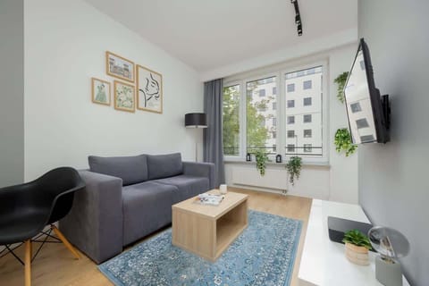 Relax in the stylish living area with a comfortable sofa and modern decor.