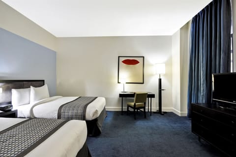Settle in together with two plush beds and workspace.