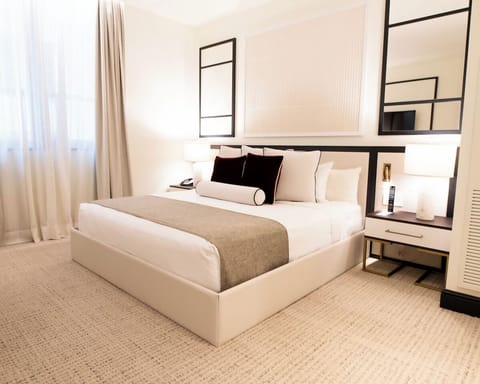 Relax in a sunlit bedroom designed for effortless comfort.