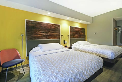 Settle into plush beds under warm lights for restful nights.