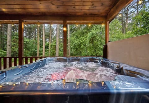 Indulge in a rejuvenating soak in the hot tub, embraced by the calming presence of the trees.