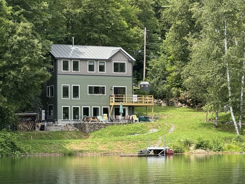 View from lake of house, rowboat, canoe, bbq, patio, deck (kayaks not shown)
