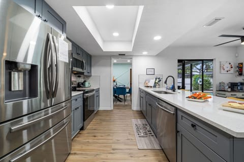 Cook together in a fully equipped modern kitchen with stainless steel appliances, spacious quartz countertops, and a large island perfect for family gatherings. This Largo Florida vacation rental makes meal prep easy and memorable for everyone.