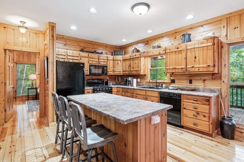 A fully equipped kitchen with wooden cabinetry and modern appliances.