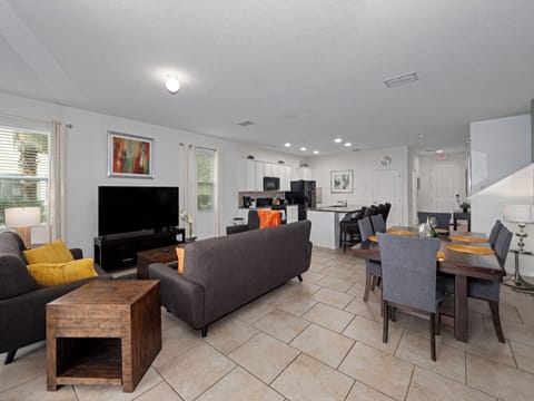 Spacious Downstairs Living Room with Dining Table and Comfortable Sofa
