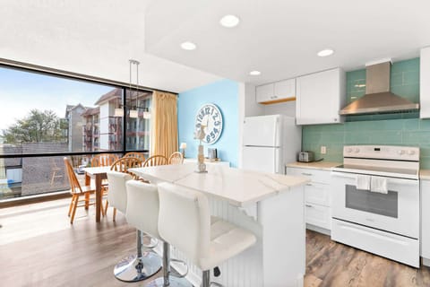 Enjoy meals with a view in this sunny dining space! The kitchen island is perfect for extra seating.