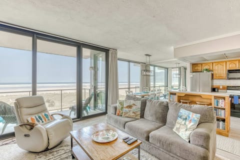 A modern, open-concept living space with large windows, cozy seating, a spacious dining area, and a bright, inviting atmosphere.