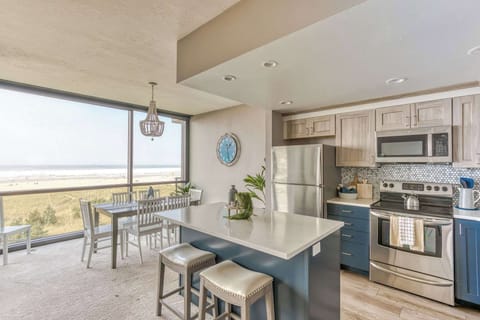 Dine with a view! Our modern kitchen and dining area offer stunning ocean vistas for memorable meals.