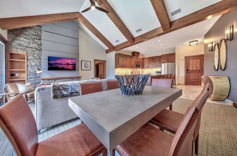 Dine in style in this beautifully appointed dining area, featuring a large table, stylish chairs, and views of the surrounding landscape.