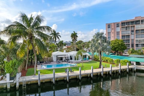 Embrace the ultimate waterfront getaway at our serene canal-front retreat, bathed in the golden glow of sunshine and framed by swaying palms